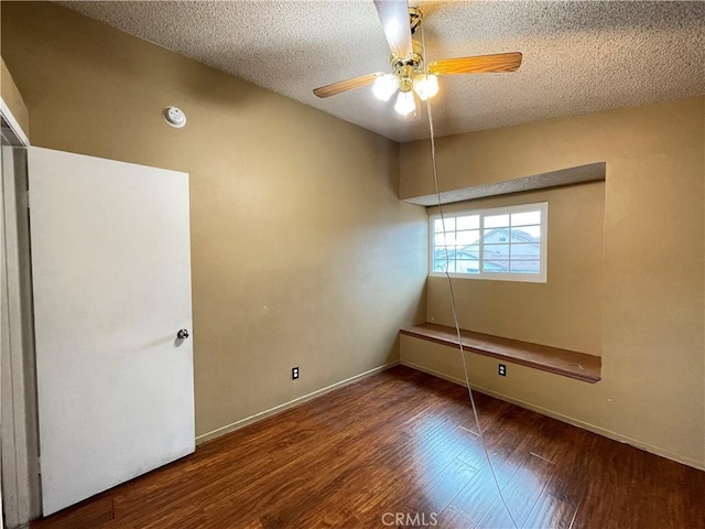 empty room featuring ceiling fan, hardwood / wood-style floors, and a textured ceiling