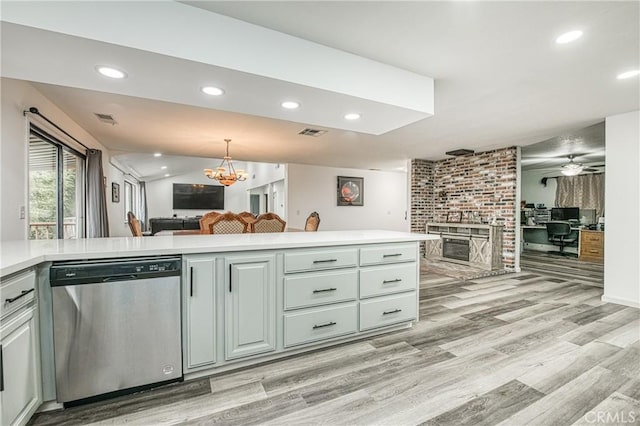 kitchen featuring stainless steel dishwasher, ceiling fan with notable chandelier, and light hardwood / wood-style flooring