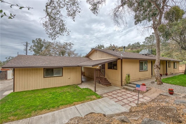 ranch-style home with a patio and a front lawn