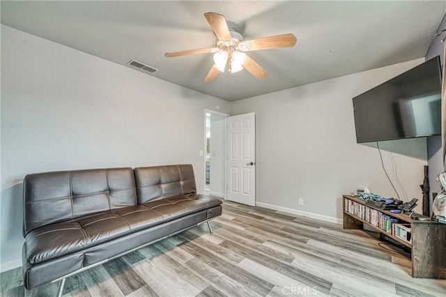 living room featuring ceiling fan and light wood-type flooring