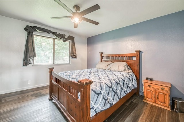 bedroom with ceiling fan and dark hardwood / wood-style flooring