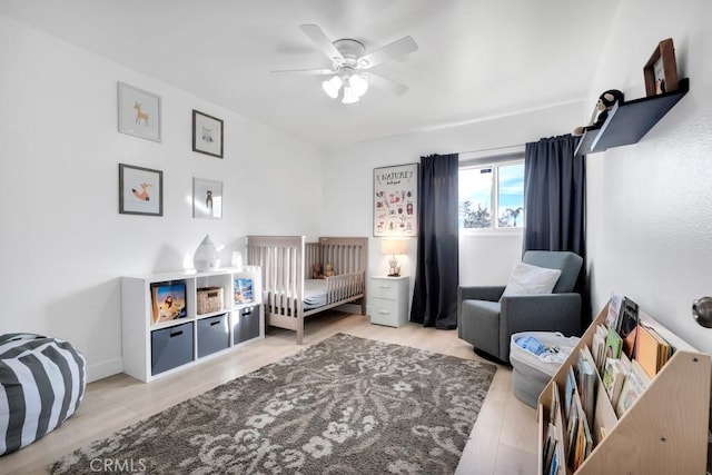 bedroom with ceiling fan and light hardwood / wood-style floors