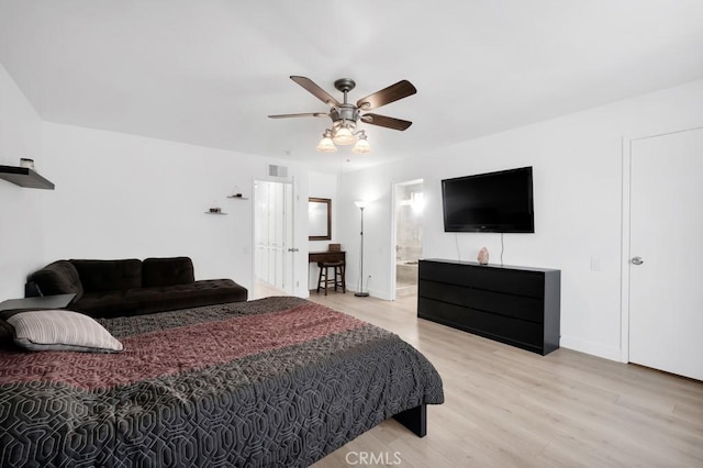 bedroom with ensuite bathroom, ceiling fan, and light wood-type flooring