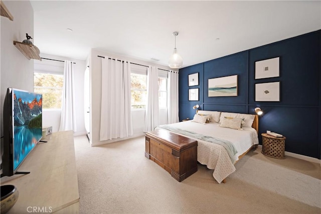 carpeted bedroom featuring multiple windows