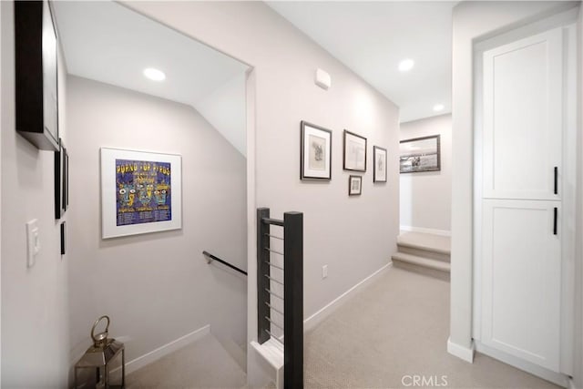 hallway featuring light carpet