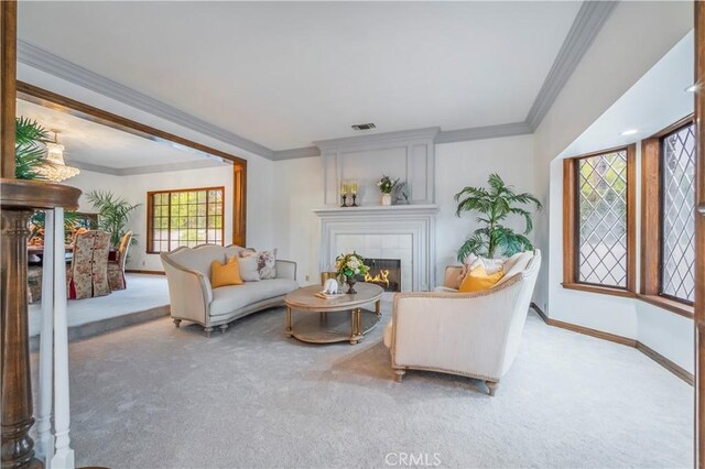 carpeted living room with crown molding and a tile fireplace