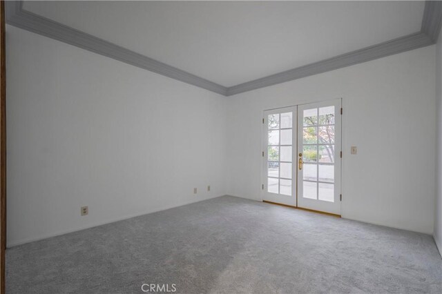 carpeted empty room featuring ornamental molding and french doors