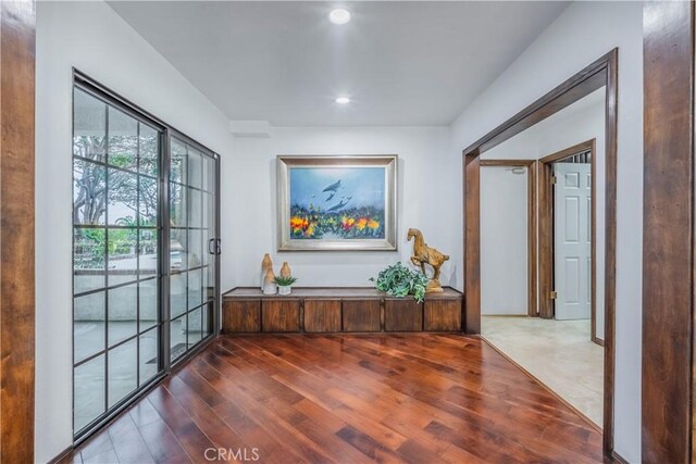 hallway featuring recessed lighting and dark wood-style flooring