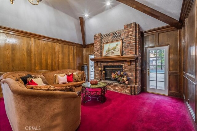 carpeted living room featuring a brick fireplace, vaulted ceiling with beams, and wooden walls