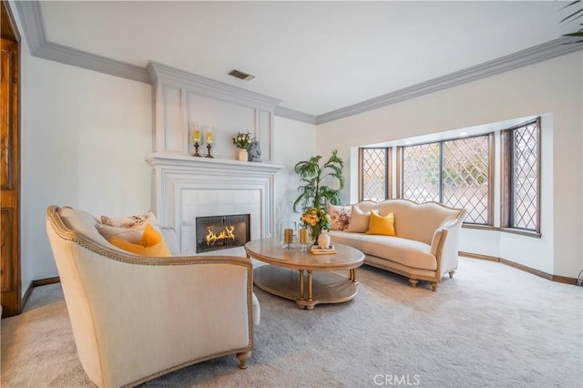 carpeted living room featuring a tiled fireplace and crown molding