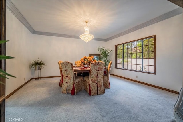 dining room with ornamental molding, carpet floors, and a notable chandelier