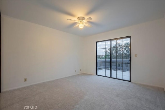 empty room featuring carpet floors and ceiling fan