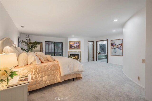 carpeted bedroom with a warm lit fireplace, baseboards, visible vents, and recessed lighting