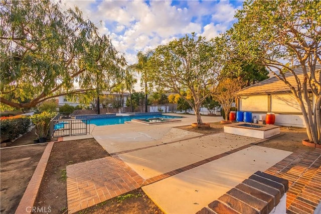 view of pool with a fire pit and a patio