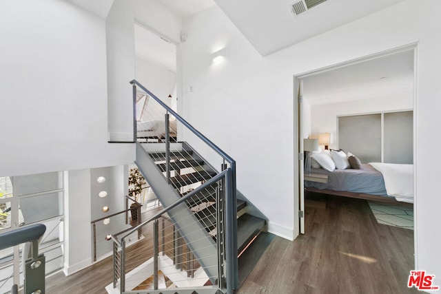 stairway featuring hardwood / wood-style floors