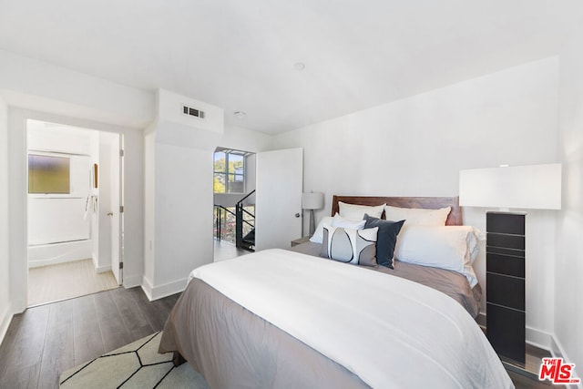 bedroom with dark wood-type flooring