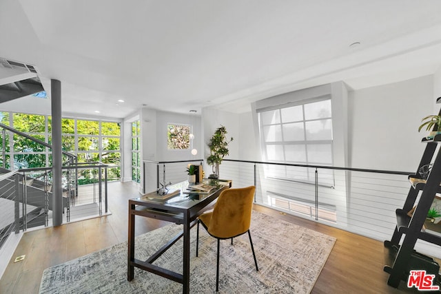 office space with floor to ceiling windows and light hardwood / wood-style flooring