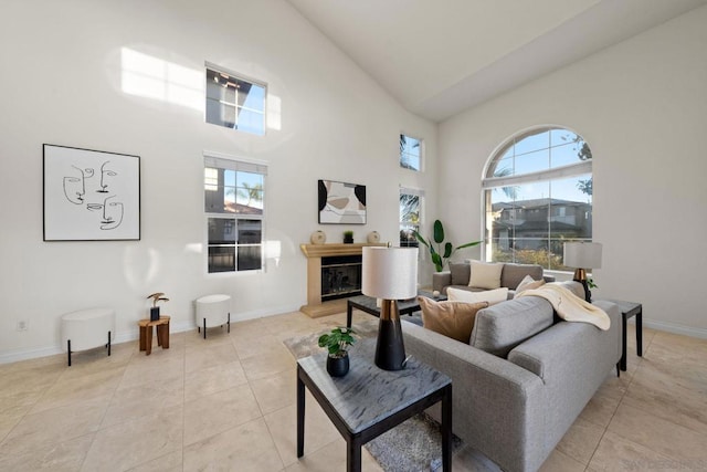 living room featuring high vaulted ceiling and light tile patterned floors