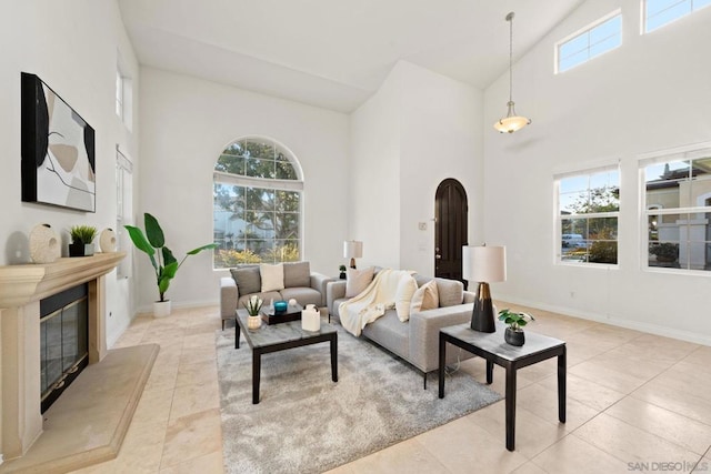 tiled living room with plenty of natural light and high vaulted ceiling