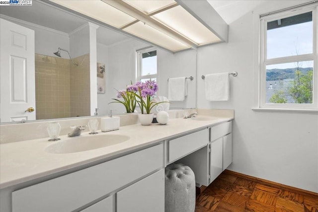 bathroom featuring vanity, a wealth of natural light, parquet flooring, and ornamental molding