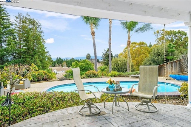 view of swimming pool featuring a patio area