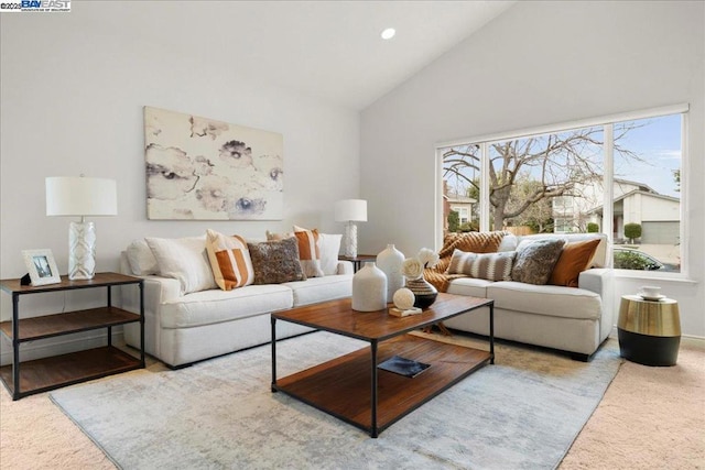 living room featuring light carpet and high vaulted ceiling