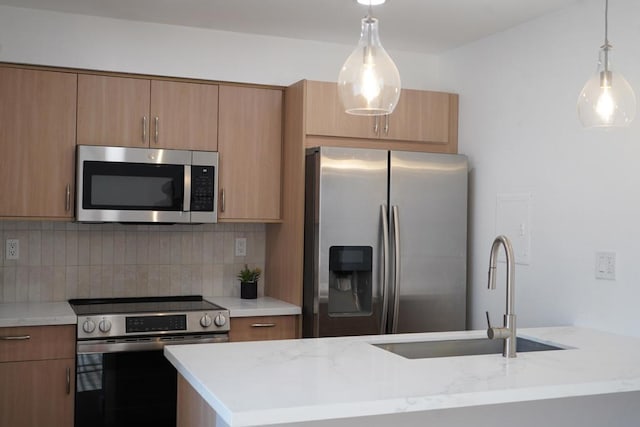 kitchen with tasteful backsplash, sink, light stone counters, and appliances with stainless steel finishes