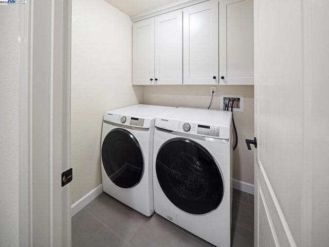 clothes washing area with cabinets, light tile patterned floors, and independent washer and dryer