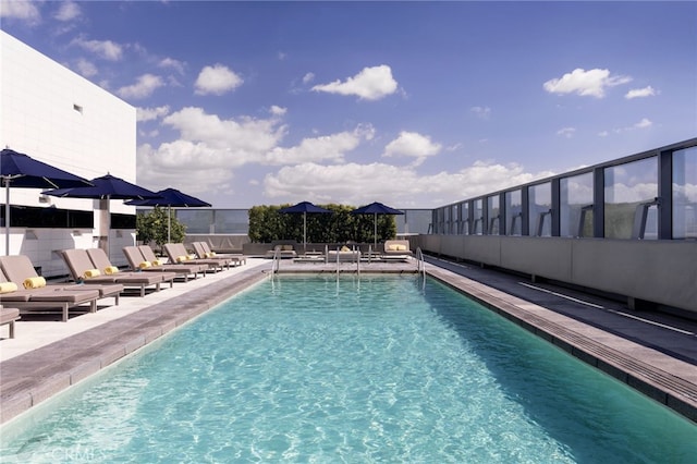 community pool with fence and a patio