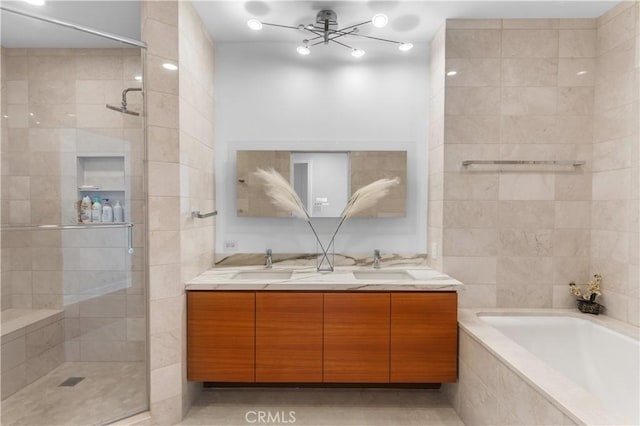 bathroom with vanity and separate shower and tub