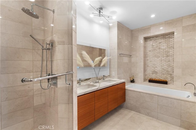 bathroom featuring vanity, shower with separate bathtub, and tile walls