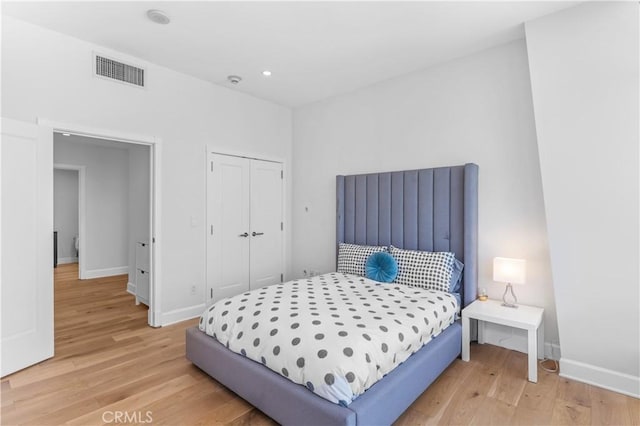 bedroom featuring hardwood / wood-style flooring and a closet