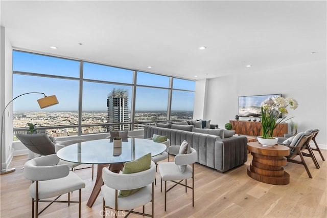 dining room featuring light hardwood / wood-style flooring and expansive windows