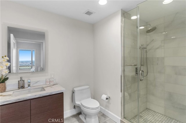 bathroom featuring a shower with door, vanity, and toilet