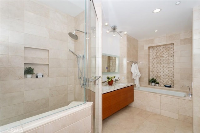 full bath featuring a sink, double vanity, tiled shower, tile walls, and a garden tub