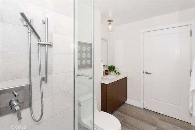 full bath with a shower stall, toilet, and vanity