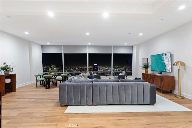 living room featuring recessed lighting, light wood-style floors, and baseboards