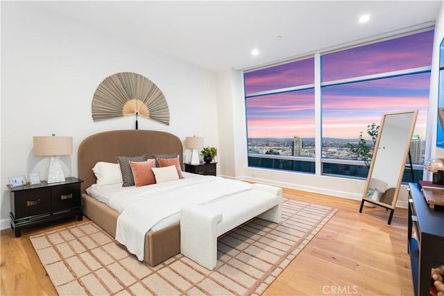 bedroom with light wood-style flooring, baseboards, and recessed lighting