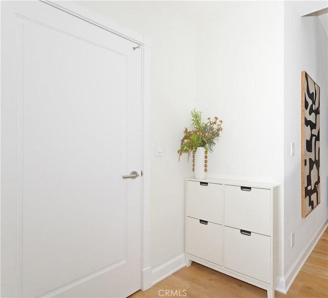 room details with baseboards and wood finished floors