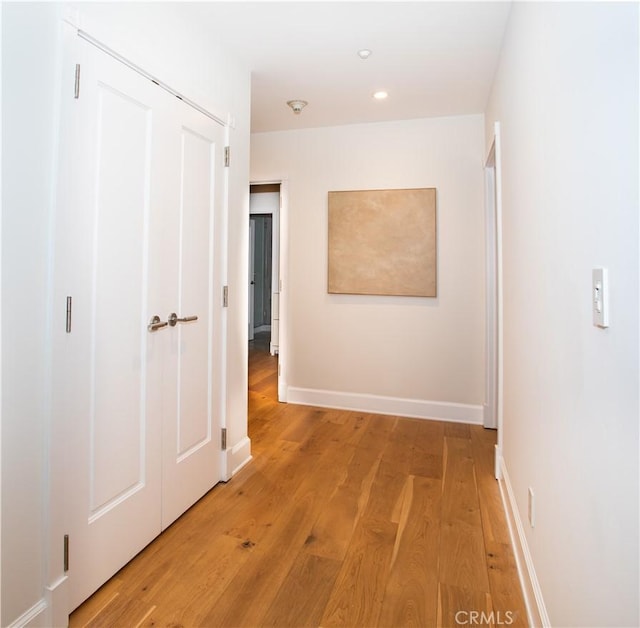 hall with recessed lighting, baseboards, and light wood-type flooring