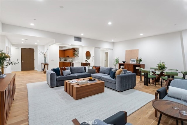 living room featuring visible vents, recessed lighting, and light wood-style floors