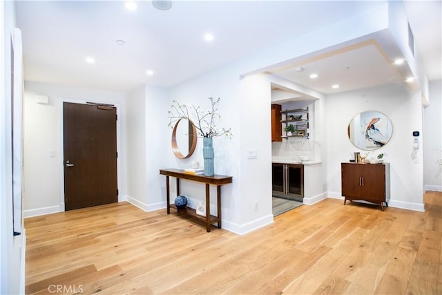 entrance foyer with light wood-style flooring, baseboards, and recessed lighting