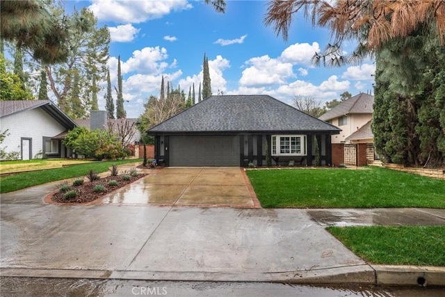 view of front of property with a garage and a front yard