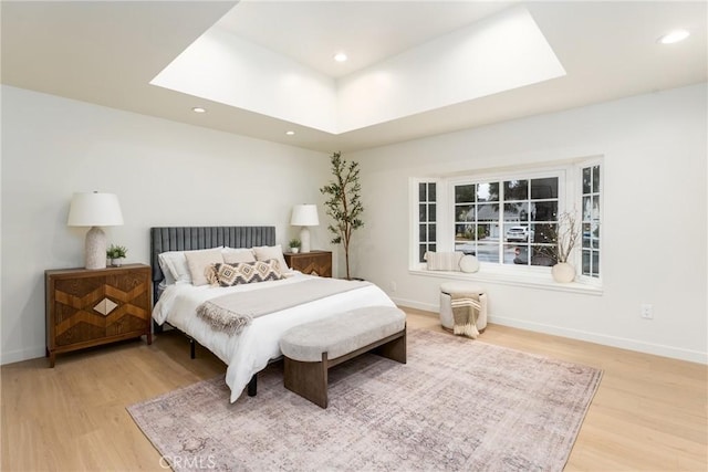 bedroom featuring hardwood / wood-style flooring and a skylight