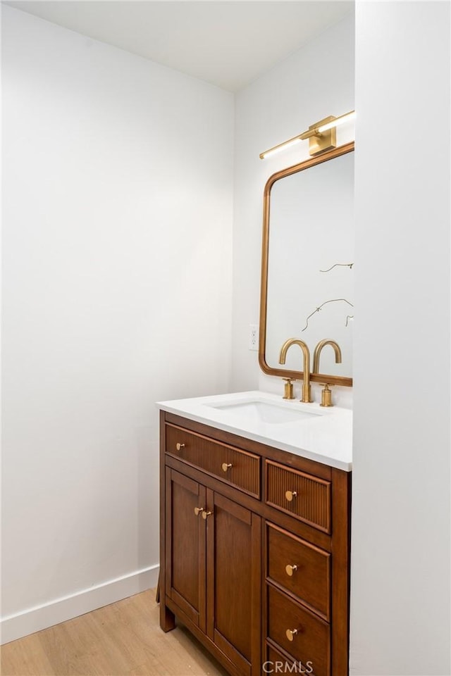 bathroom featuring vanity and hardwood / wood-style floors