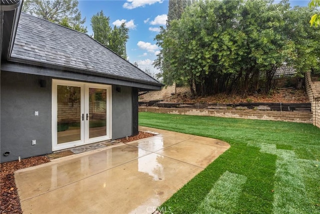 view of yard featuring a patio area and french doors