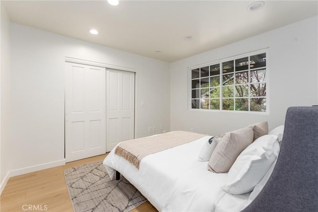 bedroom featuring light hardwood / wood-style floors and a closet