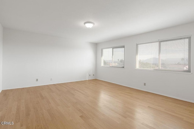 spare room featuring light wood-type flooring