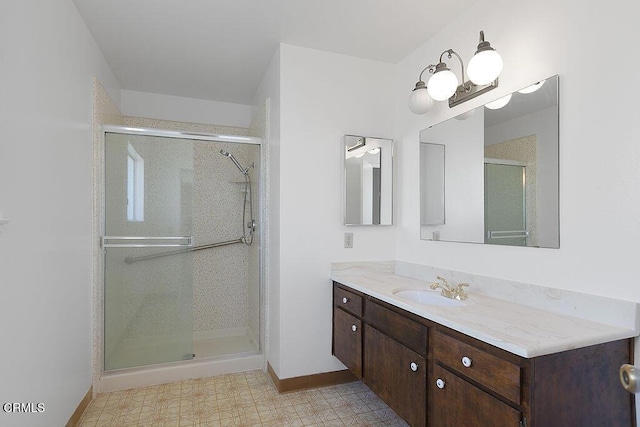 bathroom with walk in shower and vanity