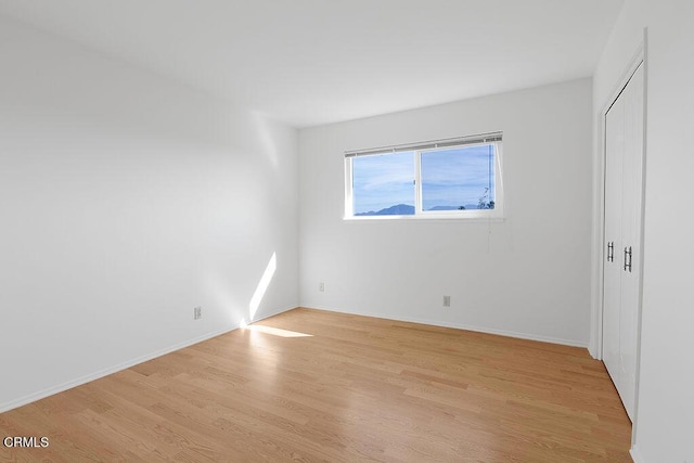 unfurnished room with light hardwood / wood-style flooring